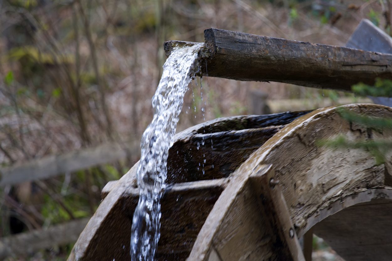 Rustic wooden water trough flowing in a wooded setting near Andersonville, Tennessee