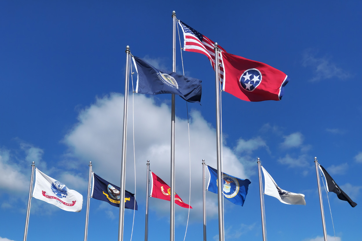 American and Tennessee flags flying beneath a clear blue sky in Bean Station, Tennessee