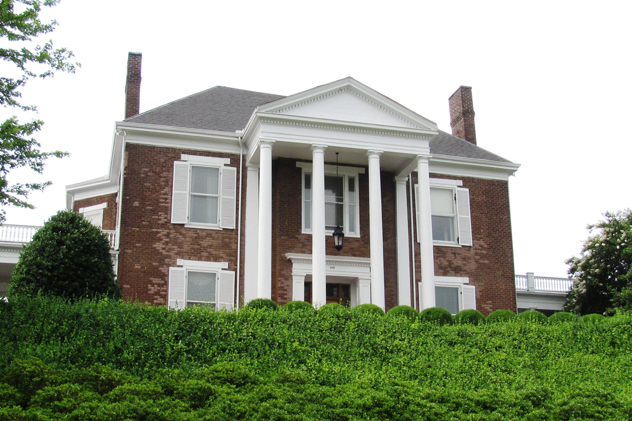 Historic brick home with white columns representing Bearden in Knoxville, Tennessee