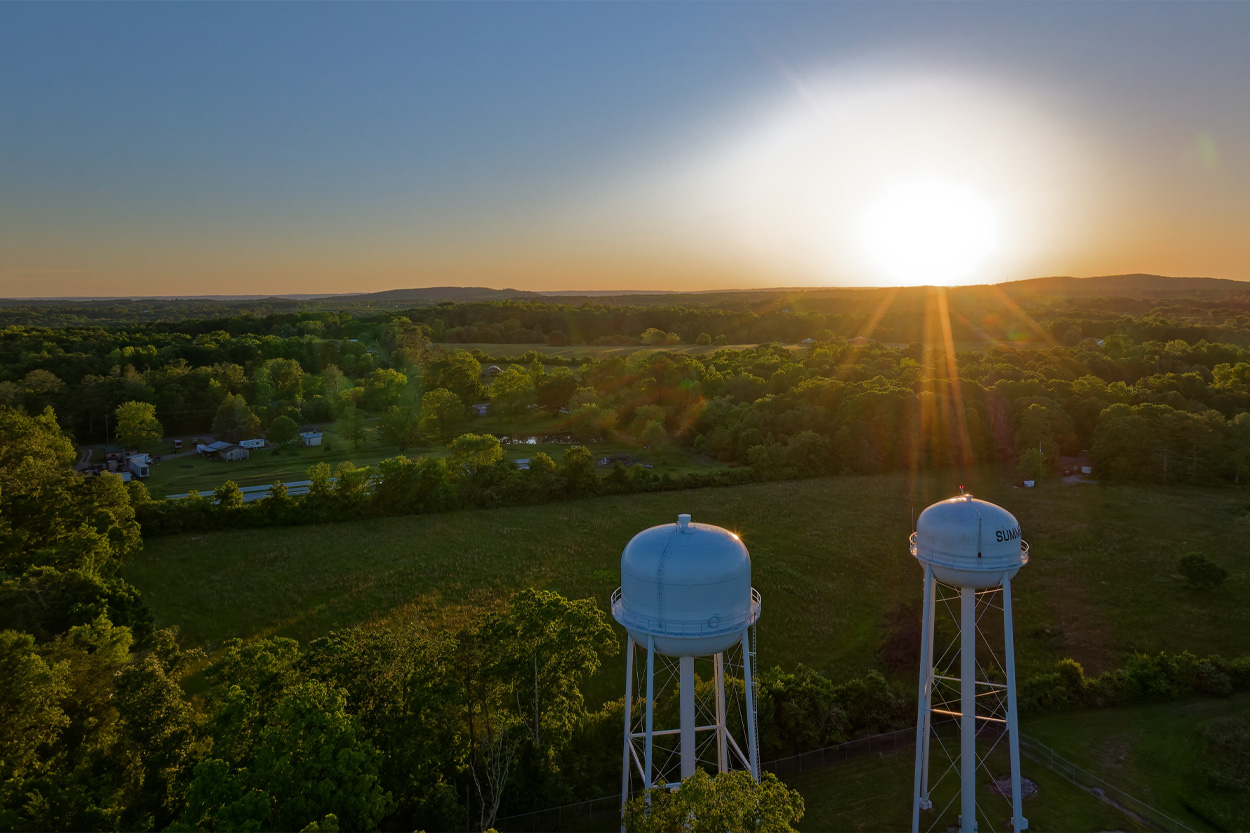 Two water towers overlooking the countryside at sunset in Dayton, Tennessee