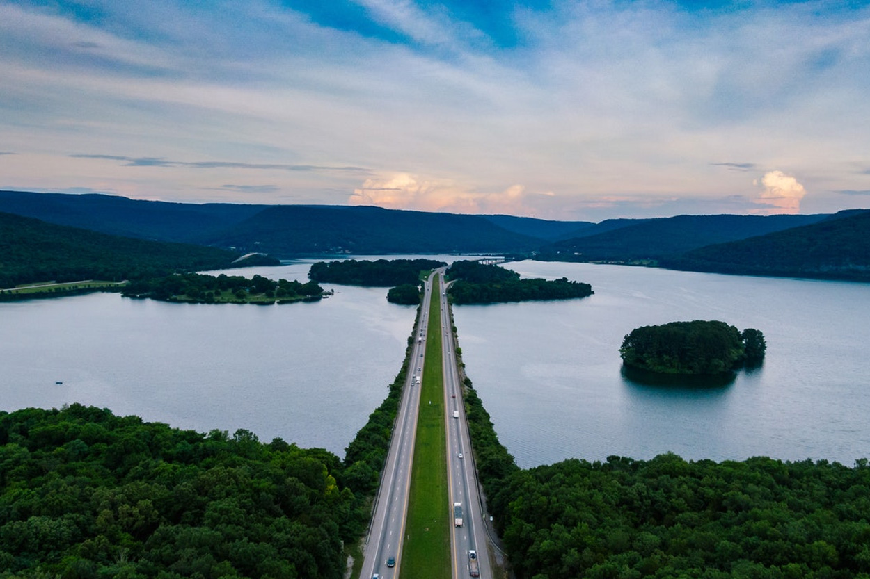 Roadway crossing a scenic lake surrounded by wooded hills near Kodak, Tennessee