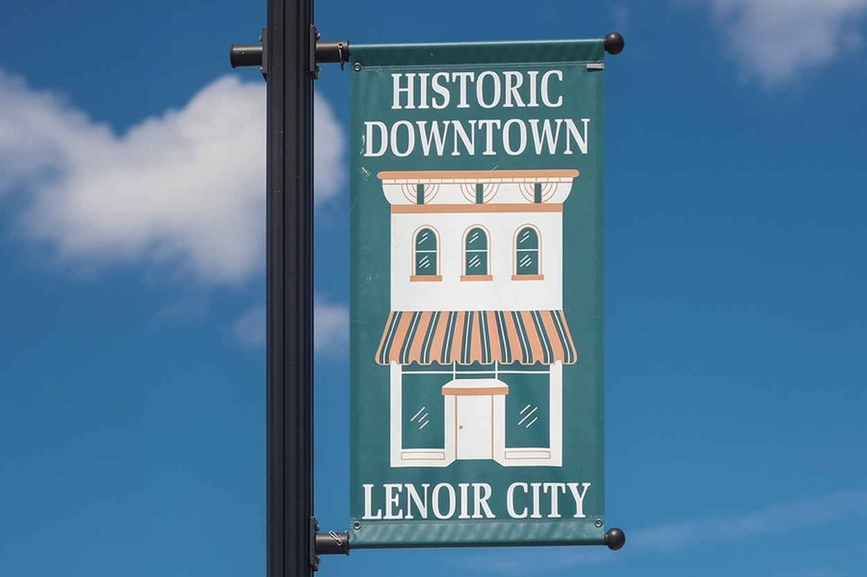 Historic Downtown Lenoir City banner displayed beneath a blue East Tennessee sky