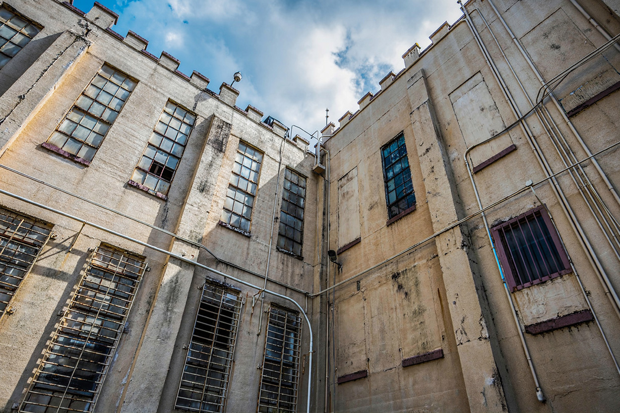 Historic stone prison building beneath a cloudy sky in Petros, Tennessee