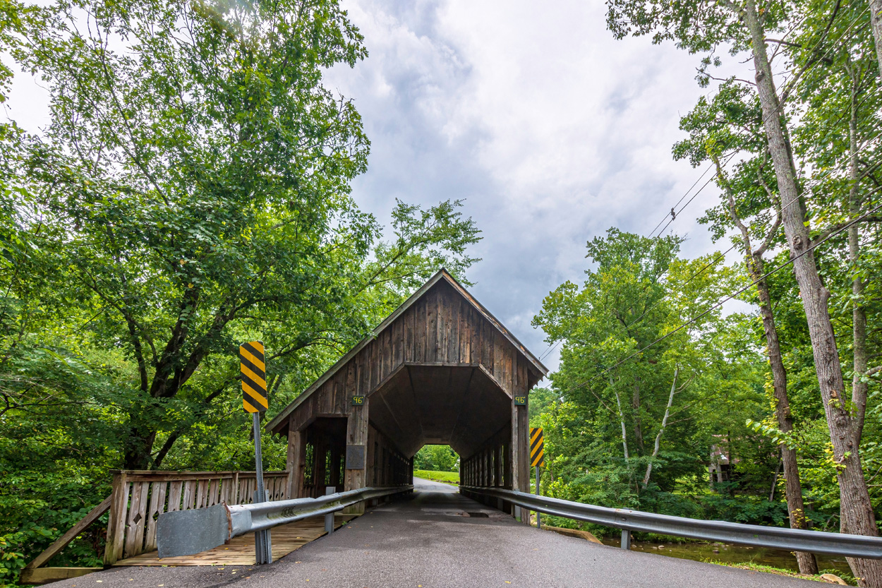 Wooden covered bridge surrounded by mature trees in Pittman Center, Tennessee