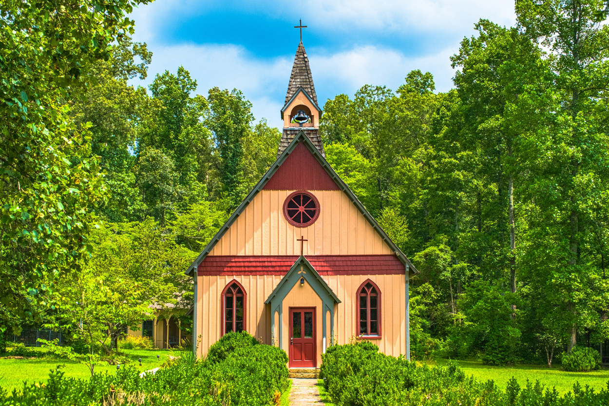 Historic wooden church surrounded by mature trees in Rugby, Tennessee