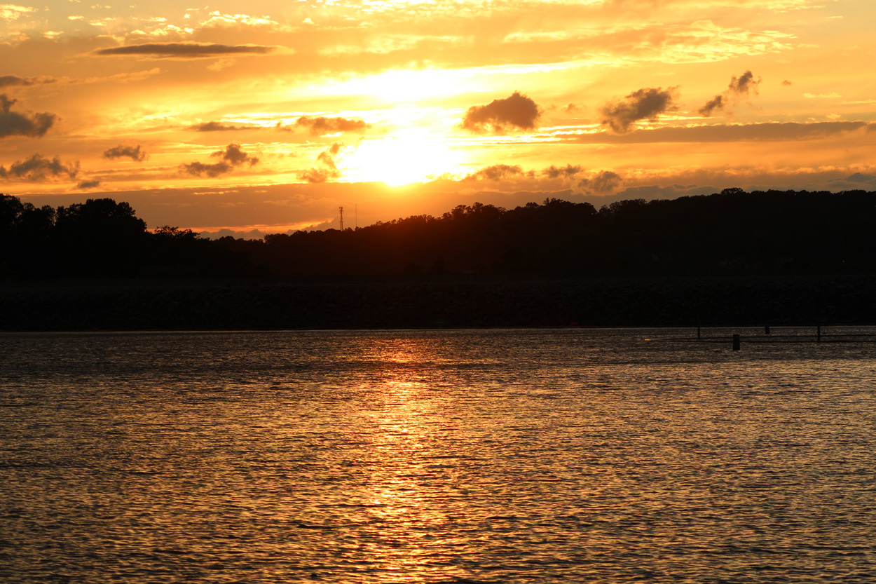 Golden sunset reflecting across calm water near Tellico Village in East Tennessee