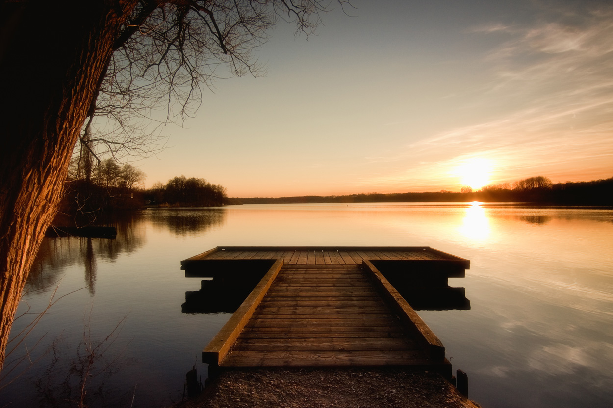 Wooden dock extending into calm water at sunset near Whitesburg, Tennessee
