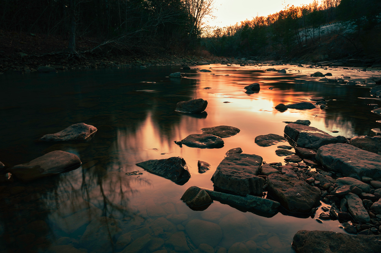 Rocky creek reflecting evening light in the wooded Witt community of Hamblen County, Tennessee