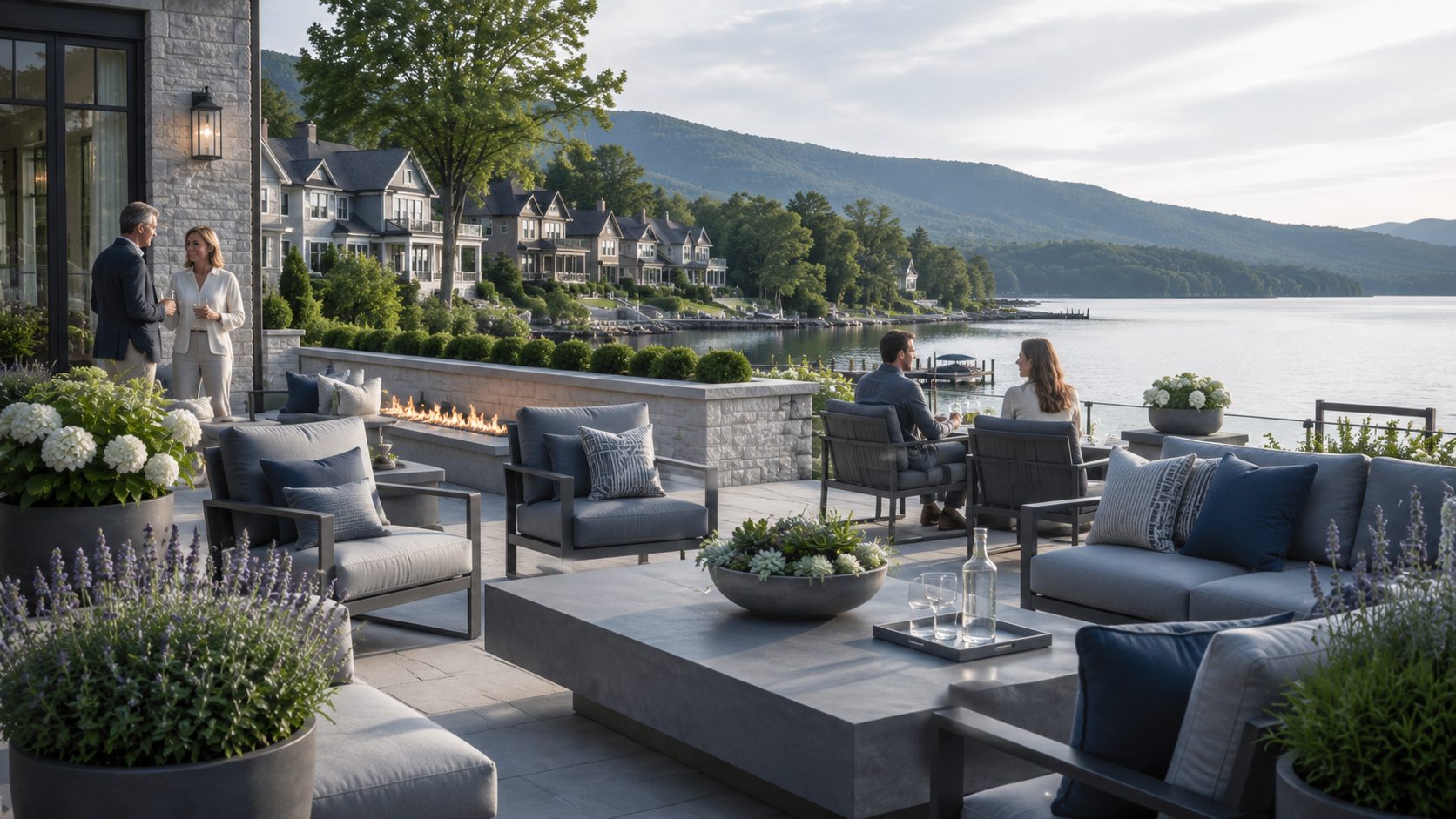 Luxury lakefront terrace with blue-gray furnishings and people connecting beside East Tennessee waterfront homes.