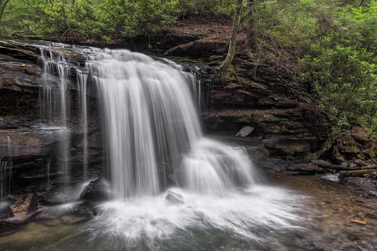 Woodland waterfall flowing over a rocky ledge in the St. Clair community of Hawkins County, Tennessee